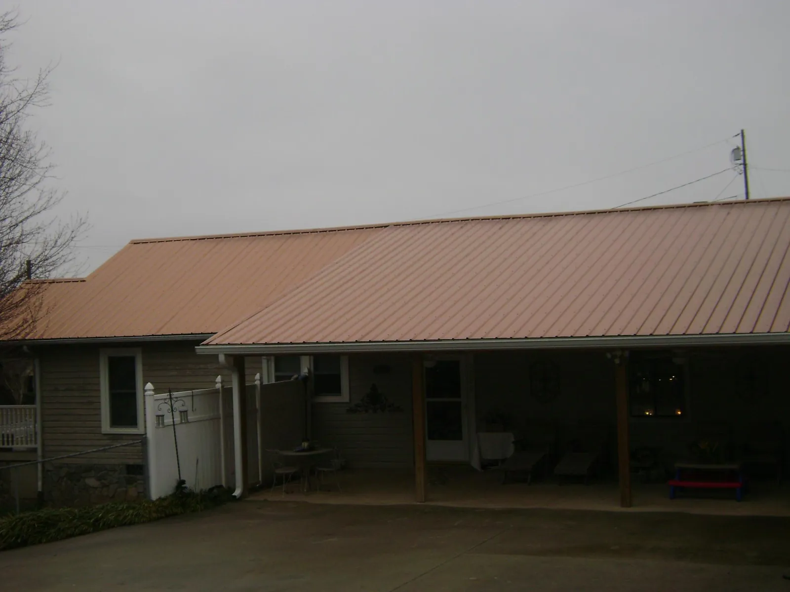 Copper toned metal roof over a wide covered patio in Highmore